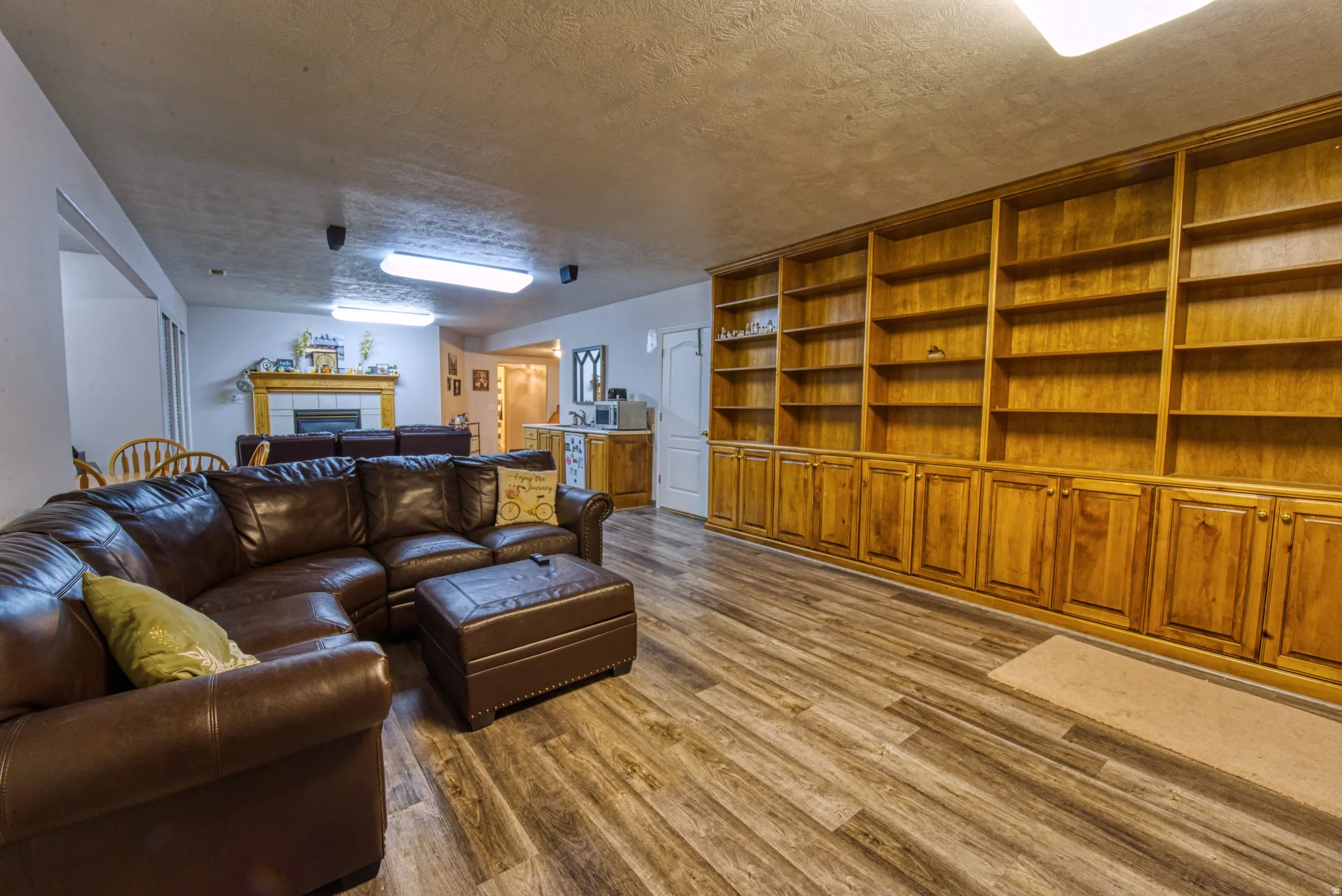 Expansive living area featuring extensive built-in wooden shelving and cabinetry