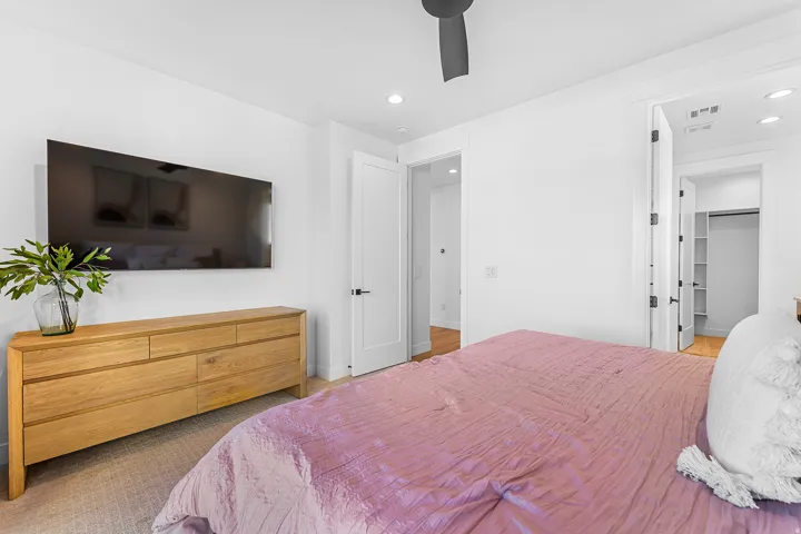 Bedroom featuring white walls and a ceiling fan