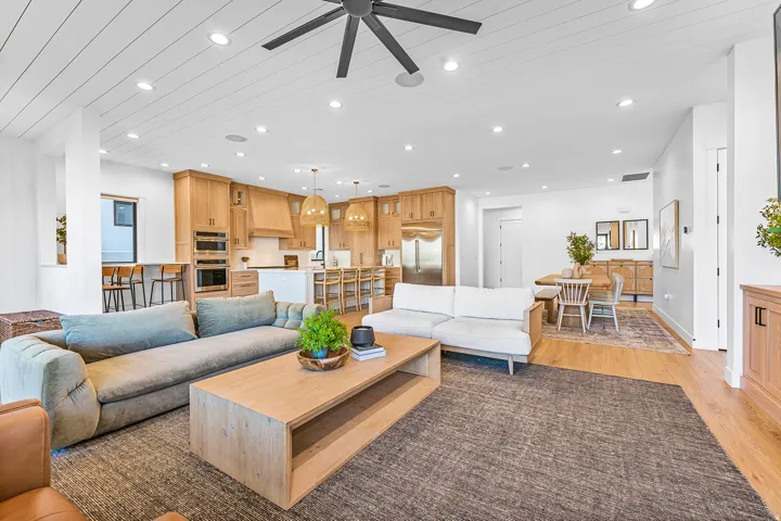 Open-concept living area with shiplap ceiling details and recessed lighting