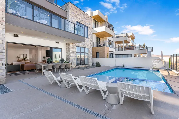 Exterior patio with a swimming pool and integrated spa