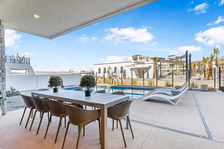 Covered patio featuring a concrete floor, stone pillar, and recessed lighting
