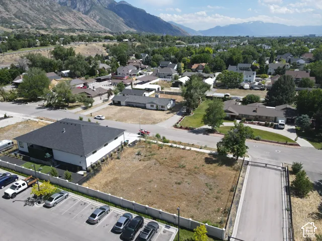 Expansive land parcel featuring clear ground, a surrounding fence, and a paved road access
