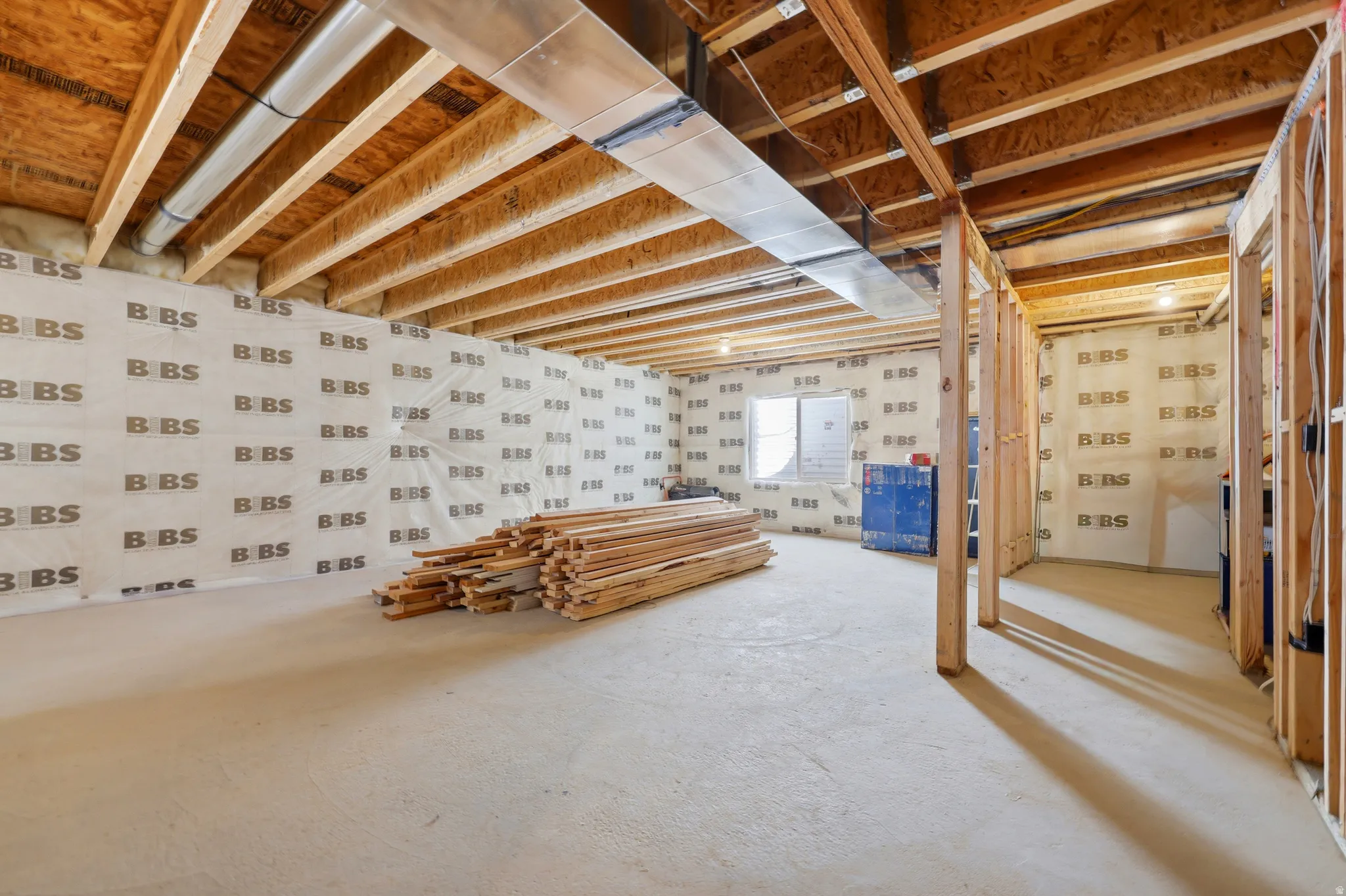 Unfinished basement offering substantial square footage, exposed ceiling joists, concrete flooring, insulated walls, and framing for potential future rooms