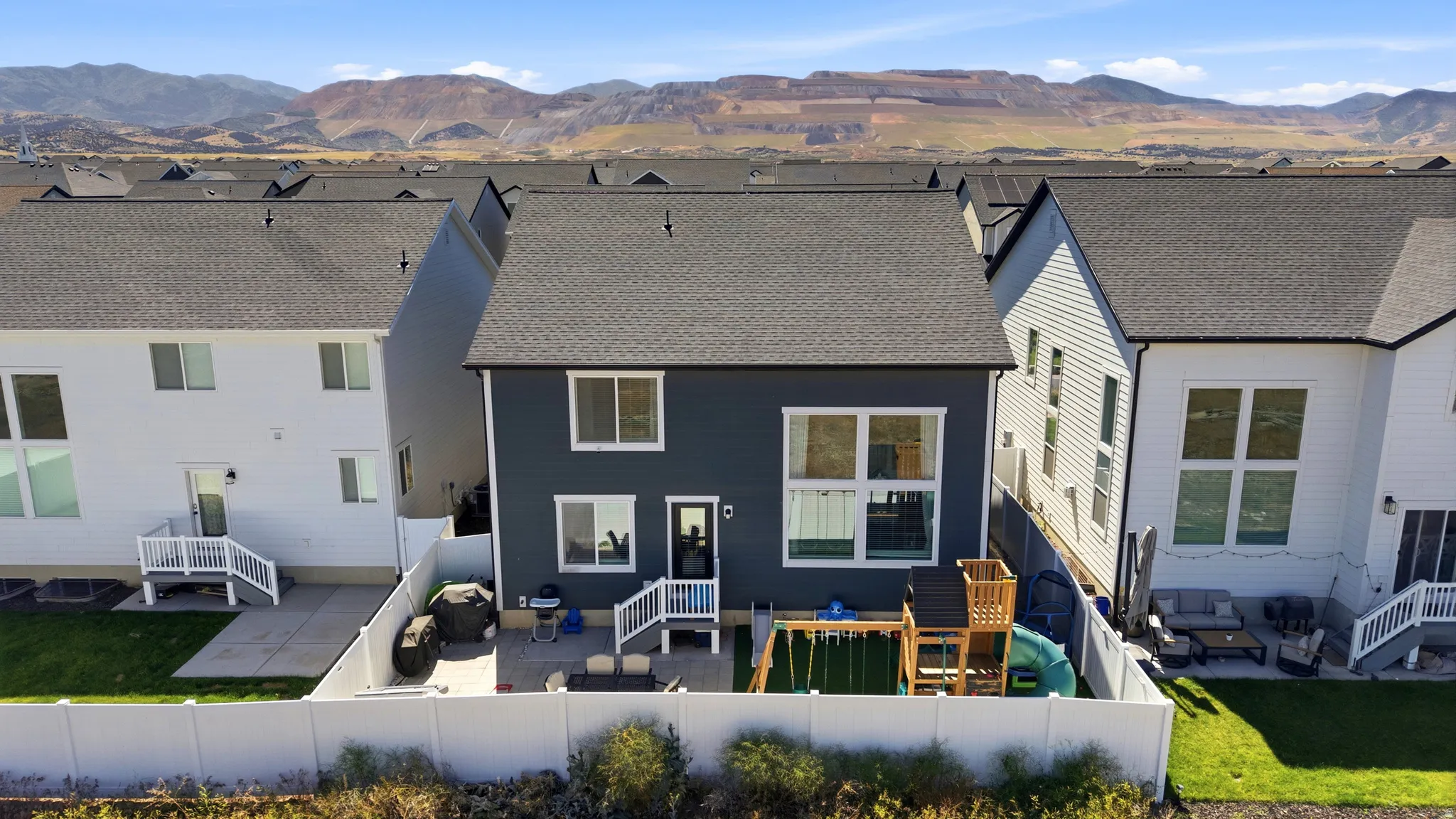 Rear exterior featuring dark-toned siding and multiple windows