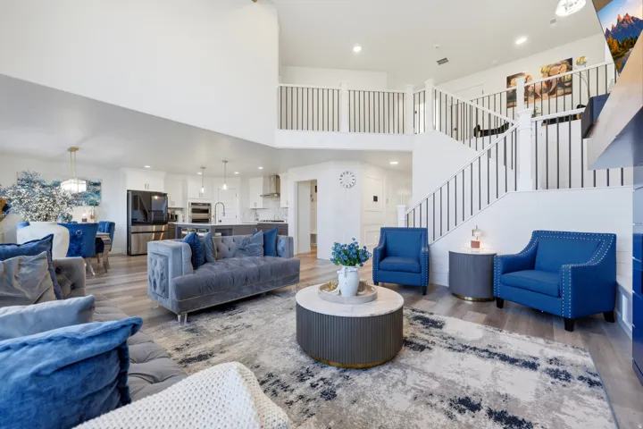 Open-concept living area with high ceilings and wood-finish flooring