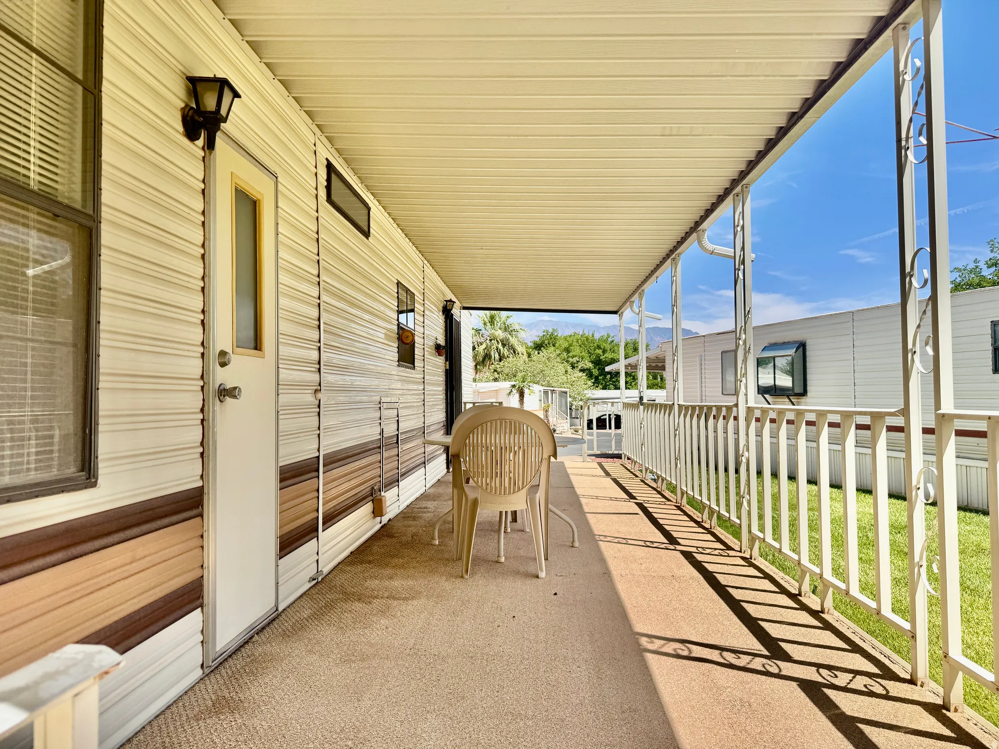 Covered patio featuring a concrete surface and decorative metal railing