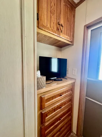 Built-in cabinetry with wood-finish doors and drawers, featuring decorative pulls and a light-toned countertop