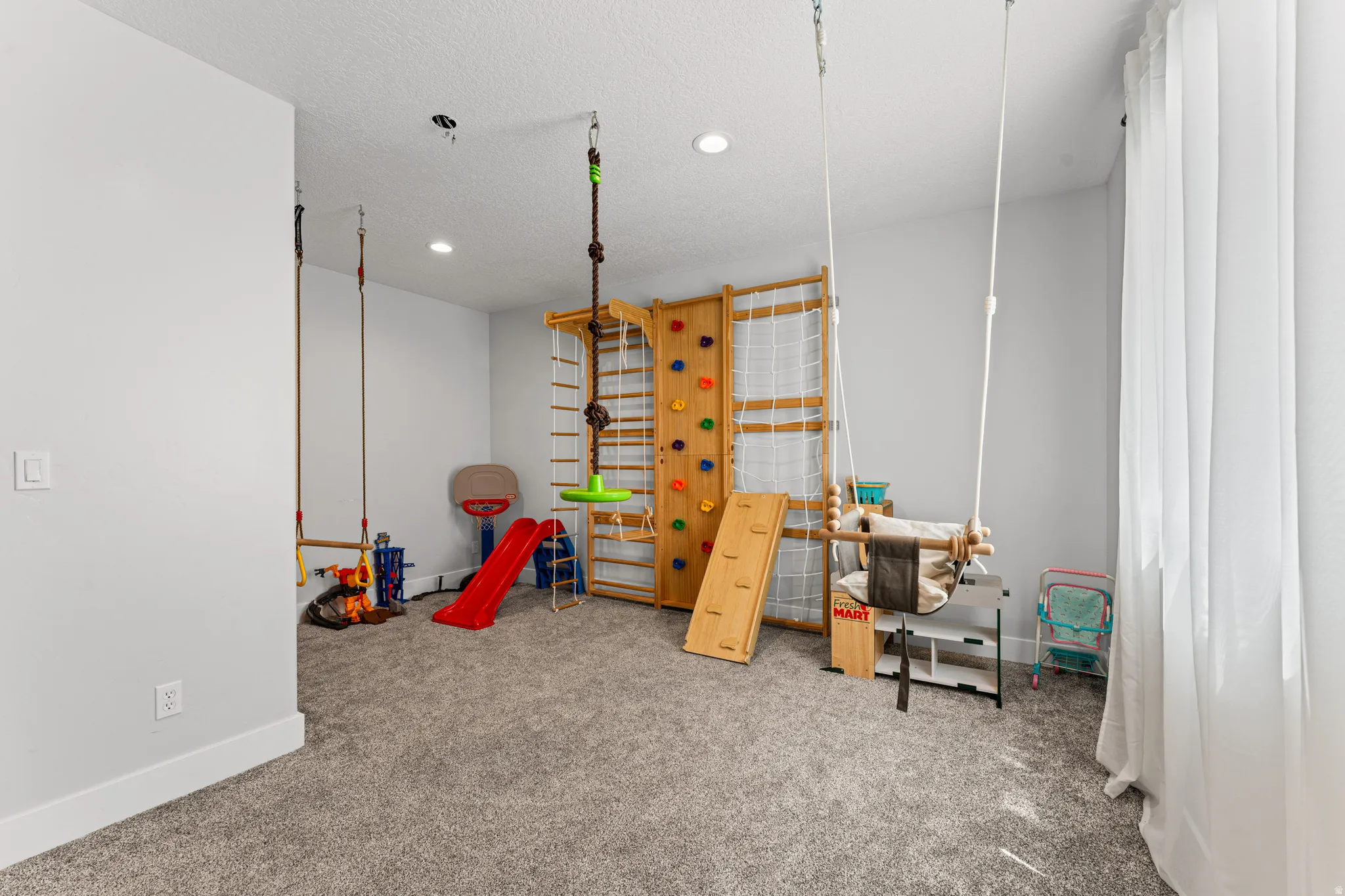 Carpeted room with recessed lighting, light gray wall paint, and white baseboards