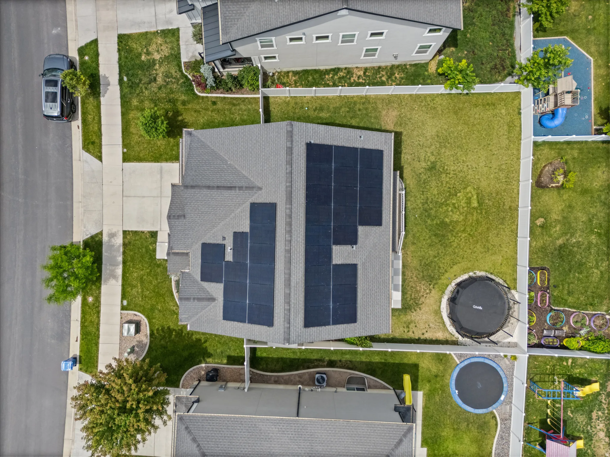 Gray shingle roof featuring multiple solar panel arrays