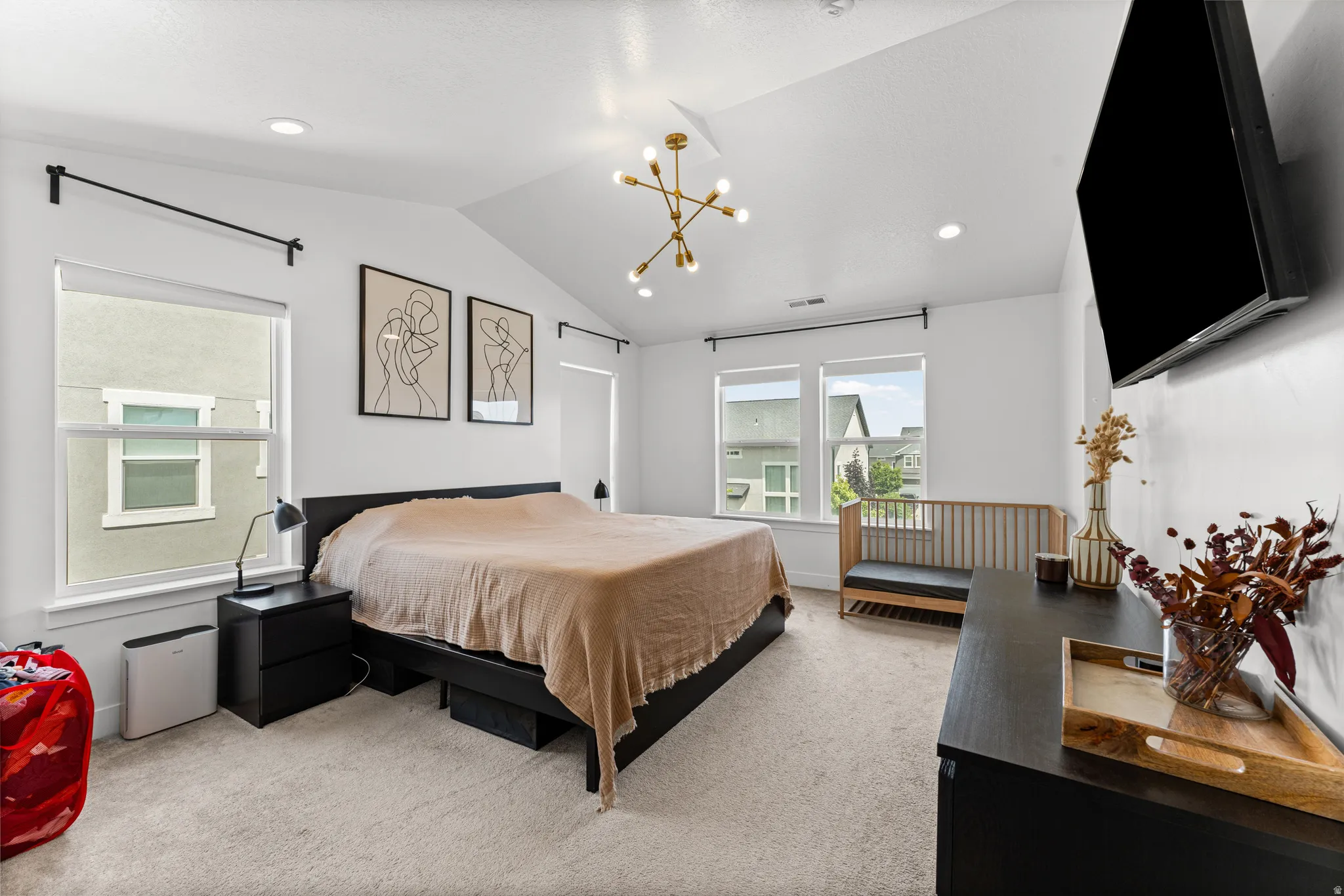 Vaulted ceilings featuring a modern light fixture and recessed lighting