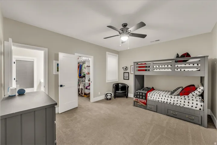 Bedroom with neutral carpet and light-toned walls