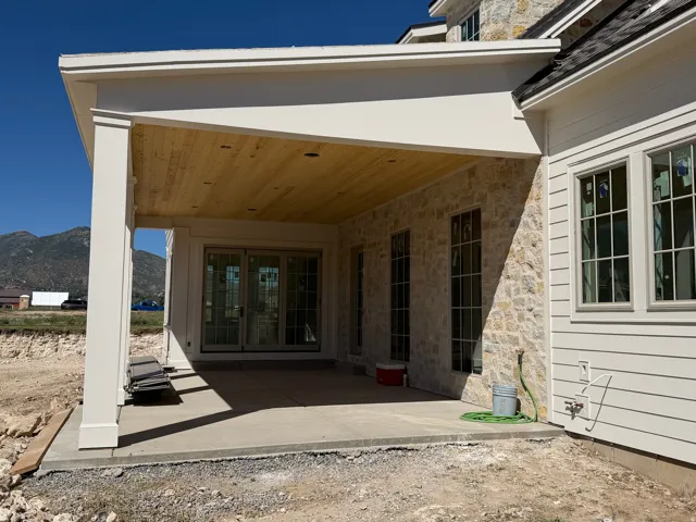 Covered patio featuring a wood-finish ceiling and stone exterior