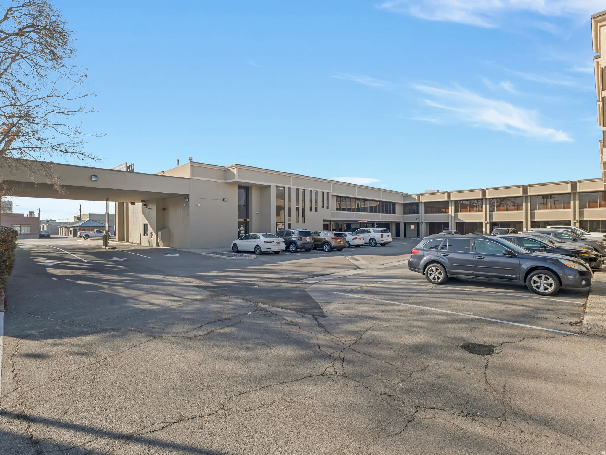 Expansive asphalt parking lot with multiple parking spaces