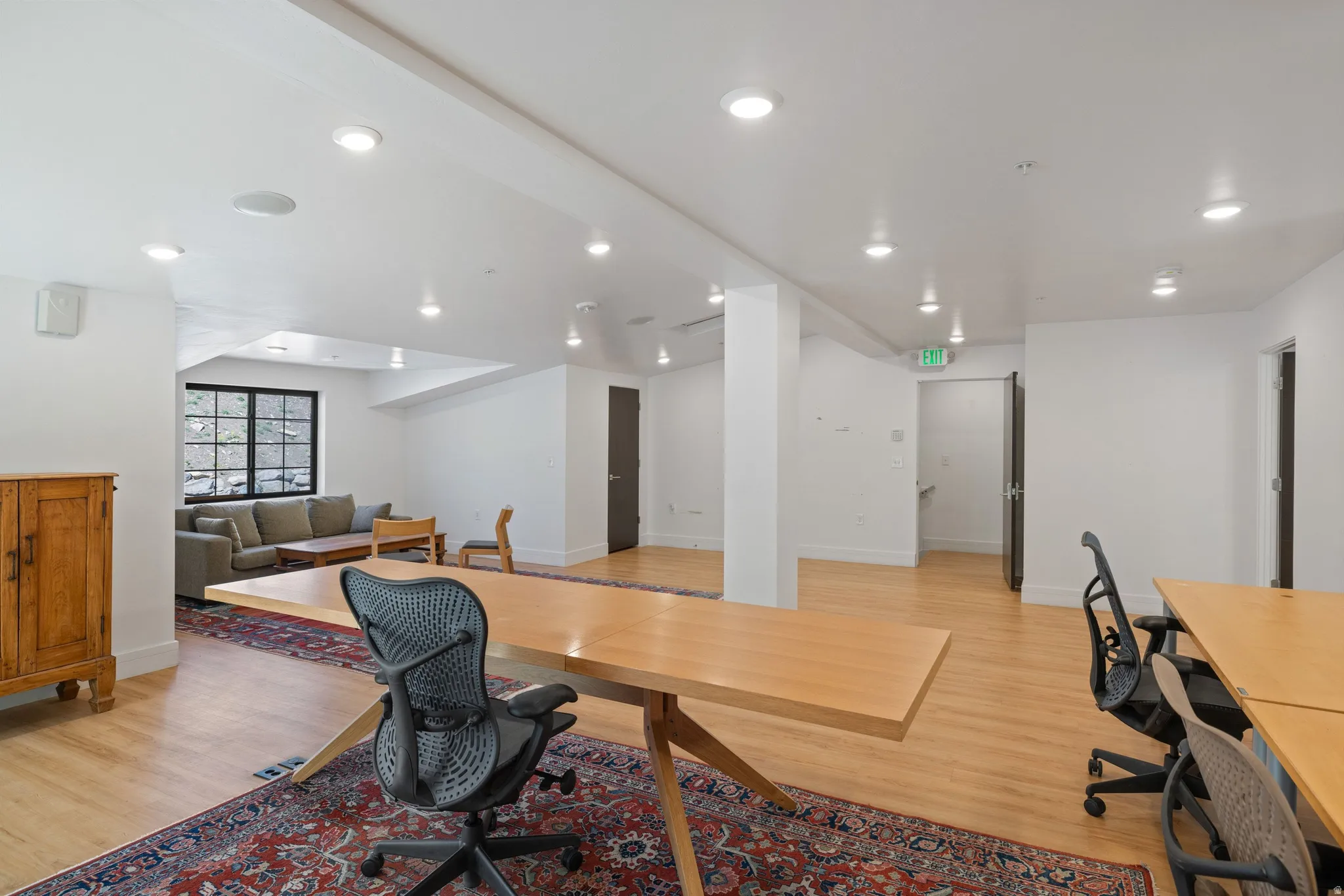 Spacious interior with light wood-finish flooring and recessed lighting