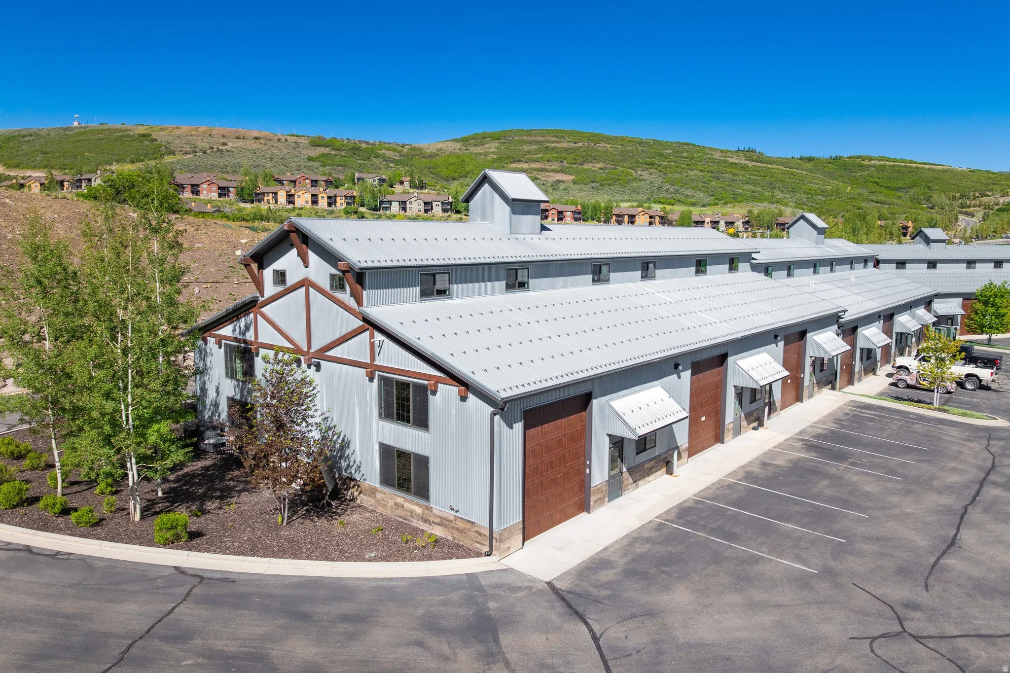 Multi-unit building featuring a metal roof and corrugated metal siding