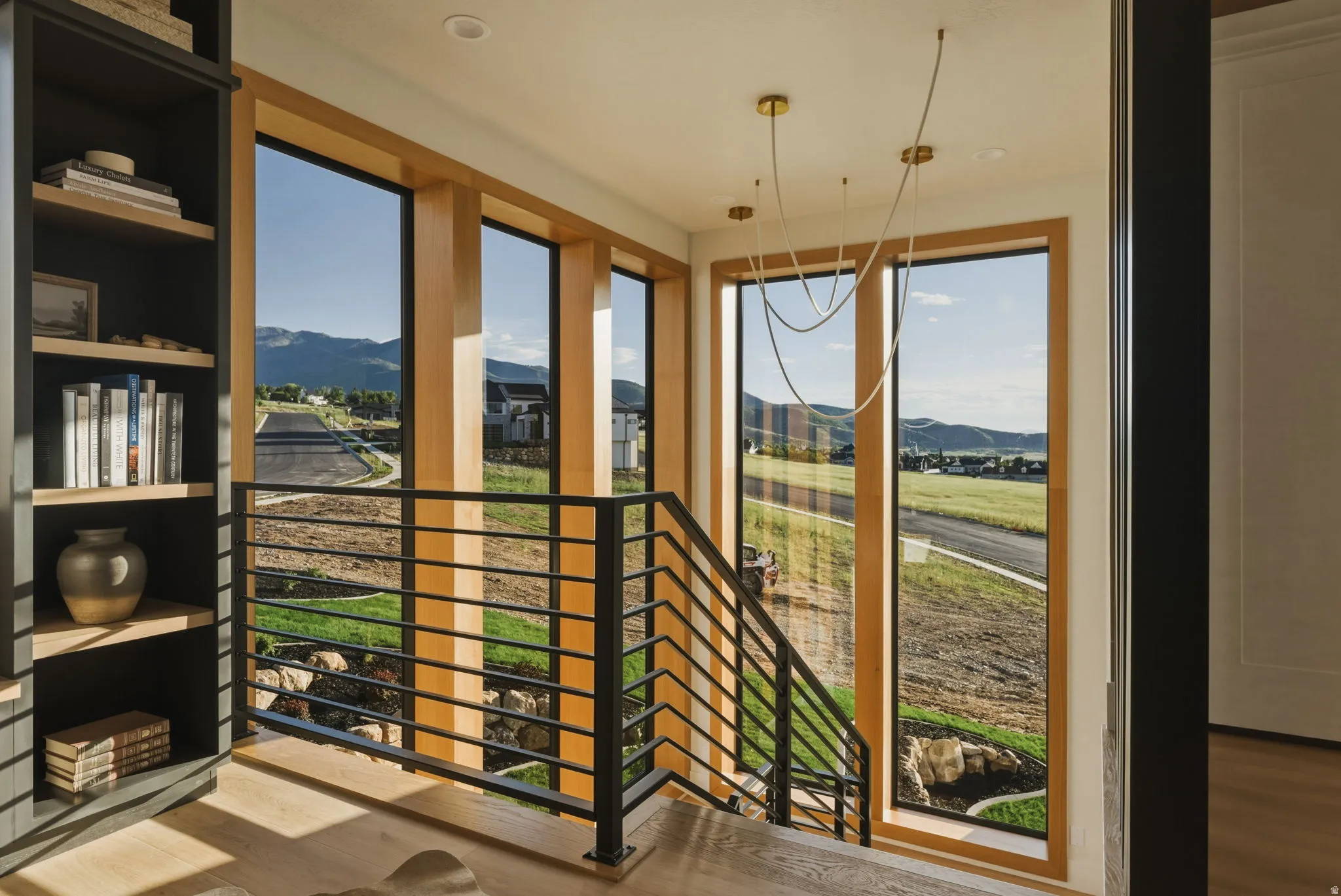 13' windows w/Modern staircase with black metal horizontal railings and light wood-finish flooring