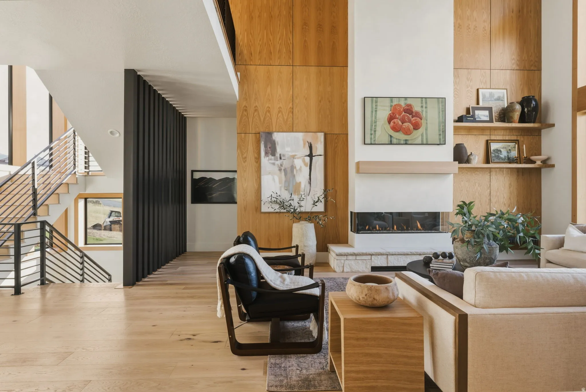 Living area featuring a floor-to-ceiling fireplace with an integrated linear gas insert and stone hearth
