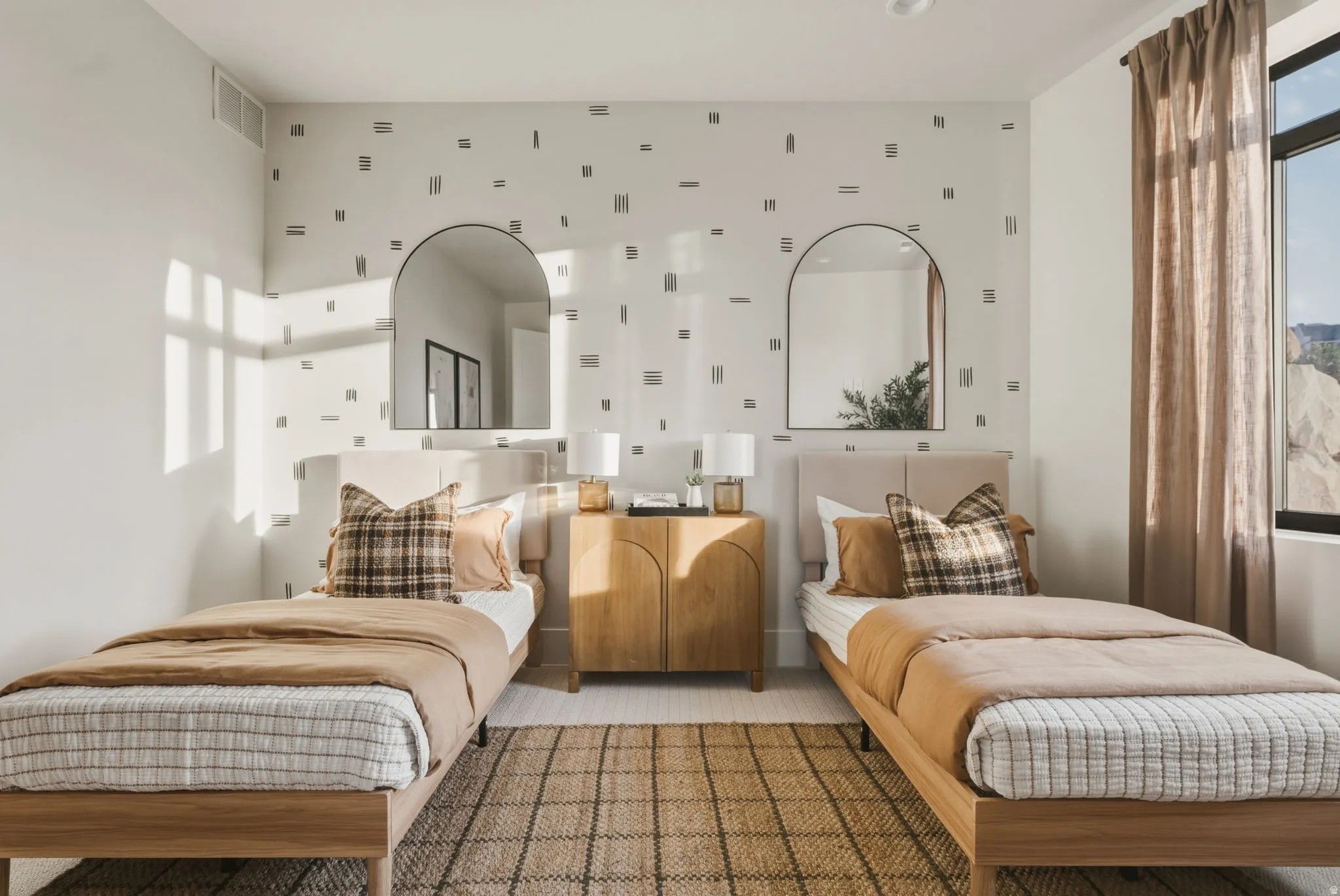 Bedroom featuring a patterned accent wall, two arched wall mirrors, and recessed ceiling lighting