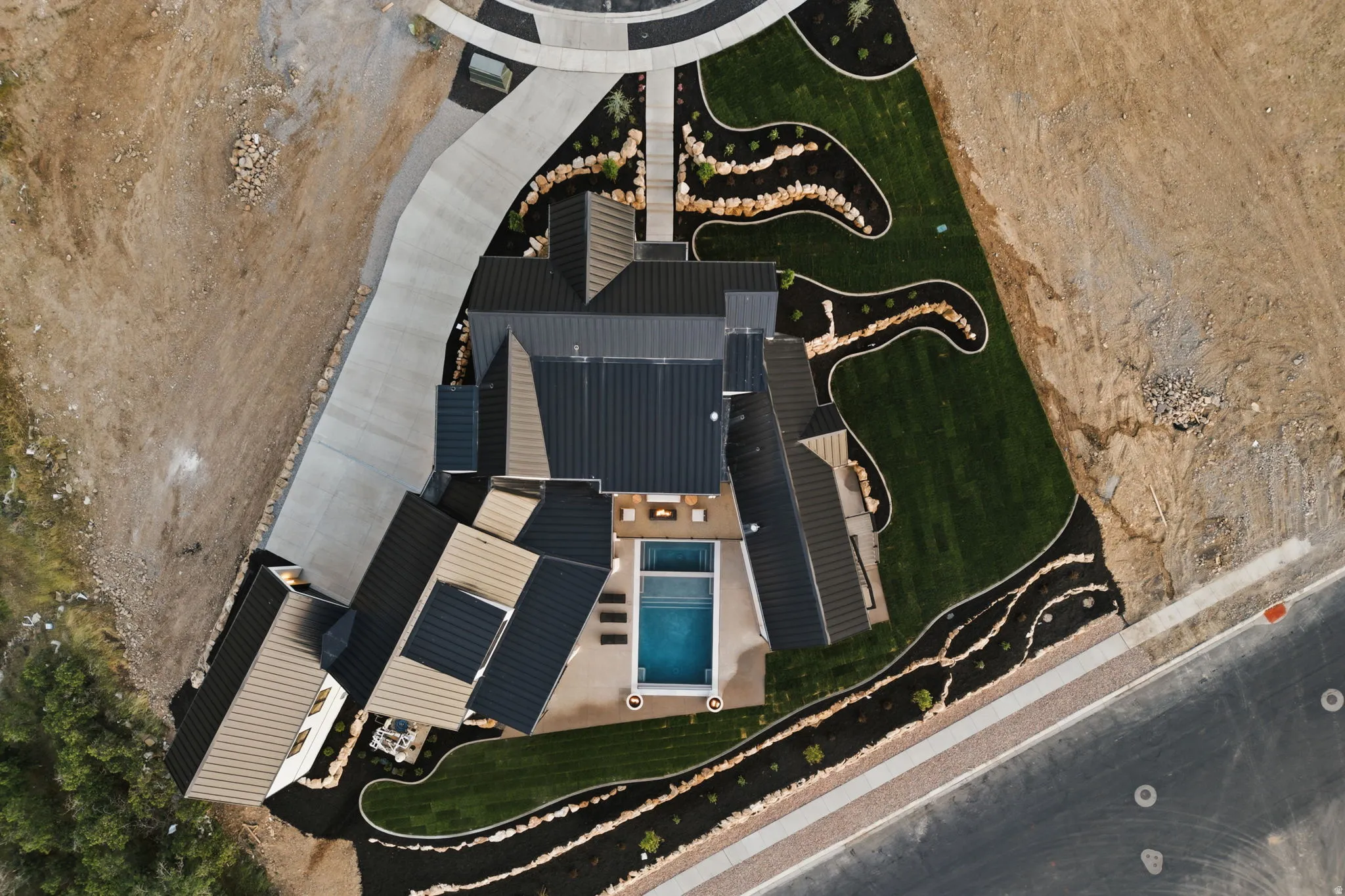 Modern property featuring a rectangular pool, integrated spa, and manicured lawn