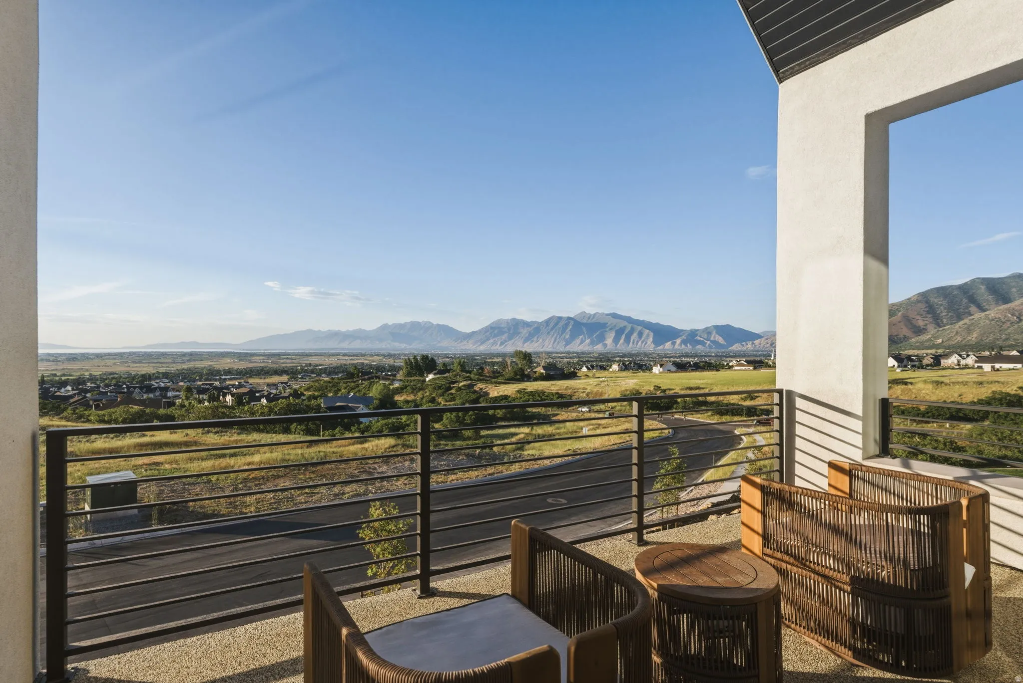 Spacious outdoor balcony with a light-colored aggregate surface