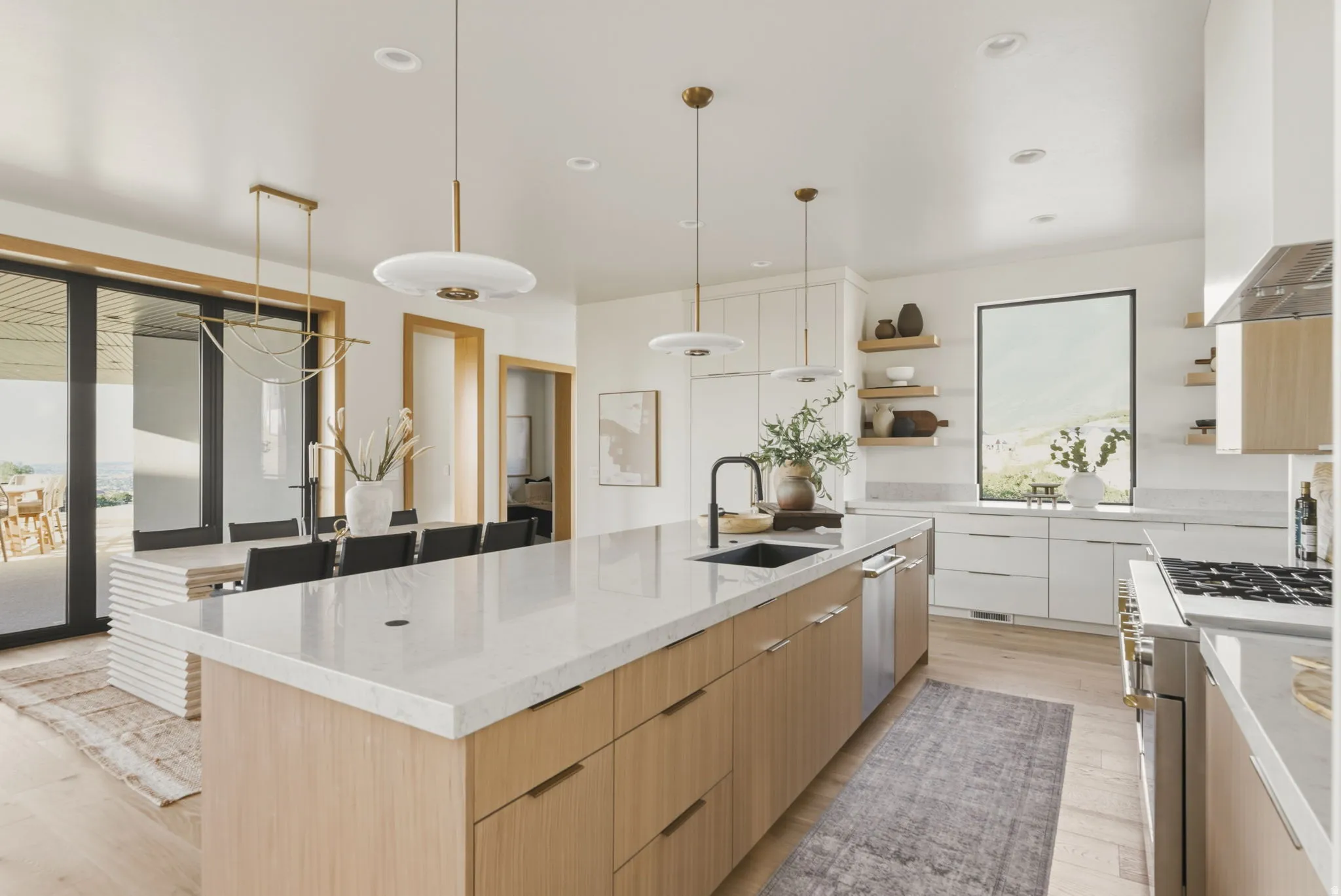 Spacious kitchen featuring a large central island with light wood-finish cabinetry and a white countertop