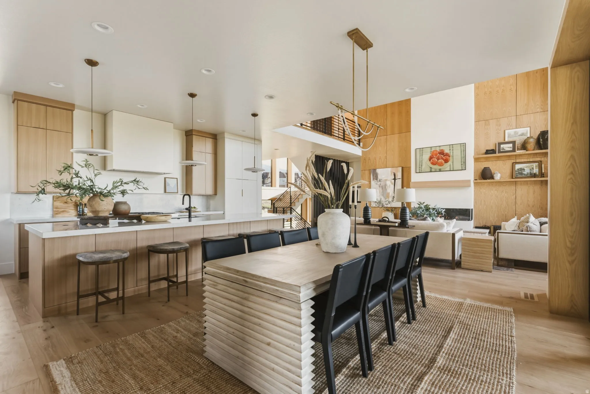Expansive open-concept living area featuring a light wood-finish flooring throughout