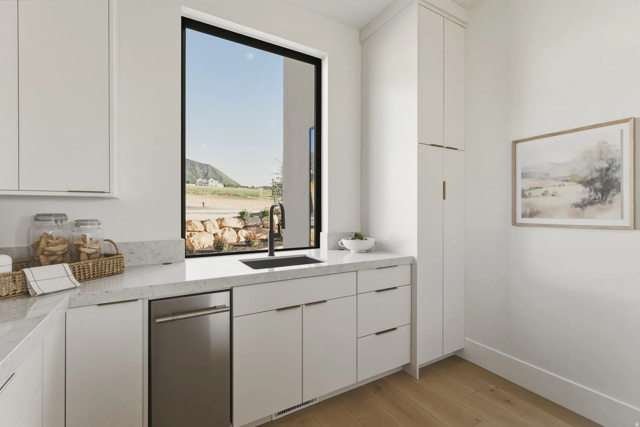 Kitchenette featuring a large picture window, undermount sink with a matte black faucet, and stone countertops