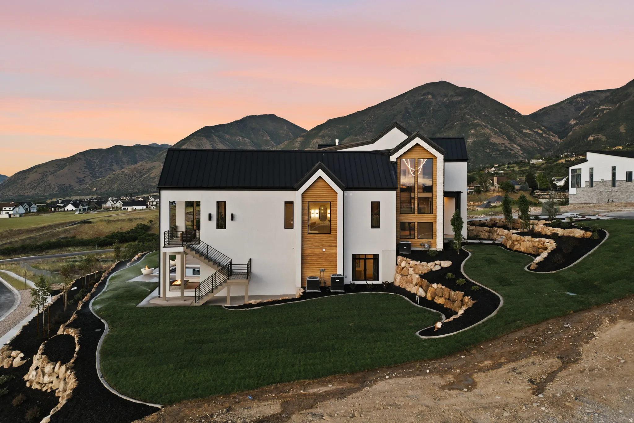 Contemporary white stucco exterior with black metal roofing