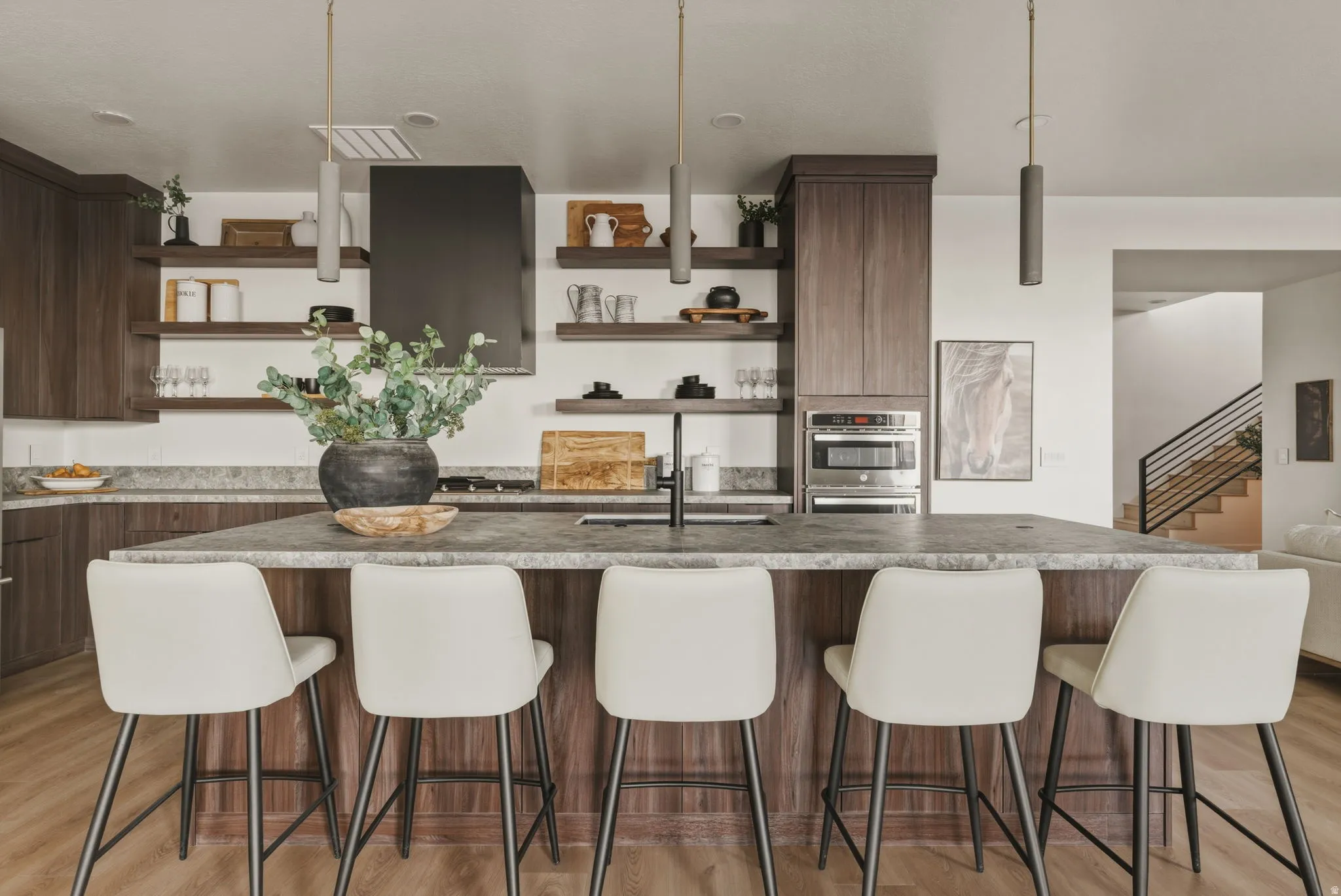 Central kitchen island featuring a substantial countertop and integrated seating