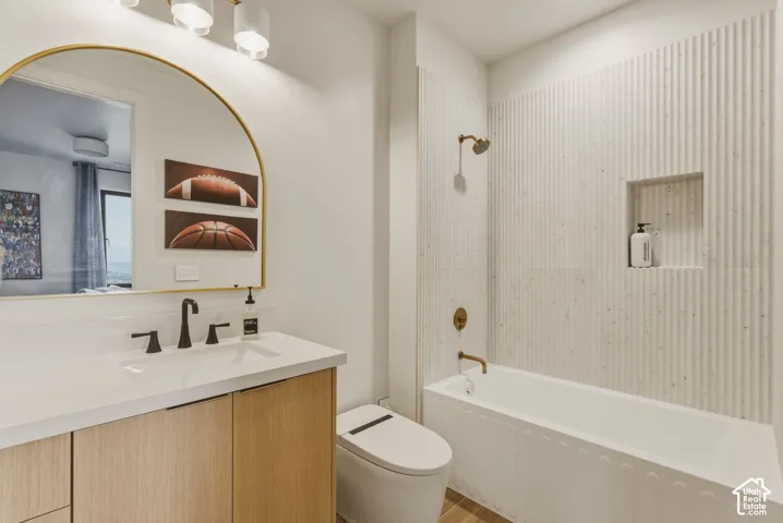 Contemporary bathroom featuring a wood-finish vanity with a white countertop and rectangular undermount sink