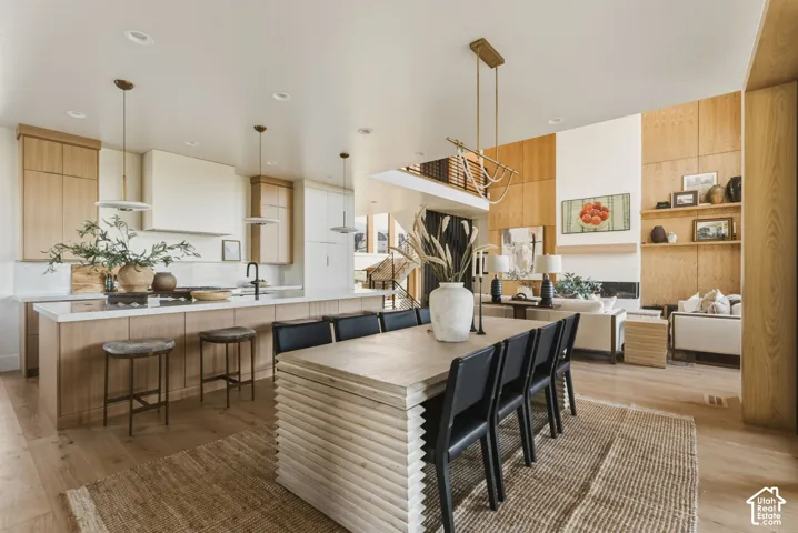 Expansive open-concept living area featuring a light wood-finish flooring throughout