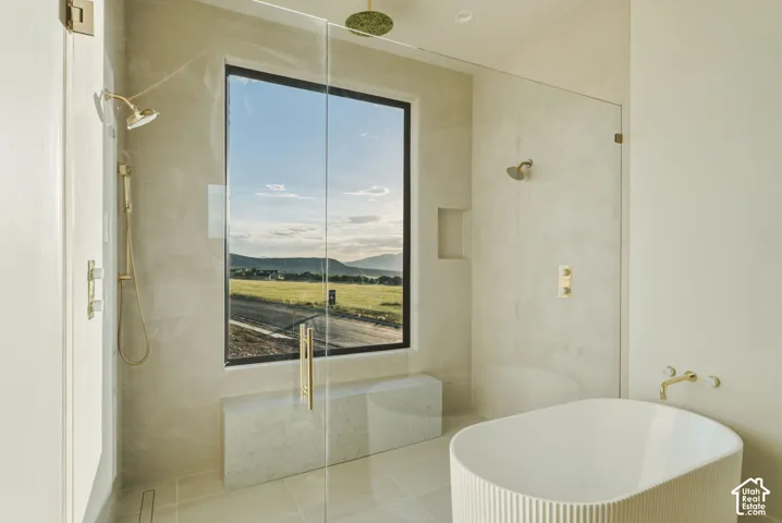 Contemporary bathroom featuring a spacious glass-enclosed shower with gold-tone fixtures, a freestanding soaking tub, a built-in shower bench, and a large picture window