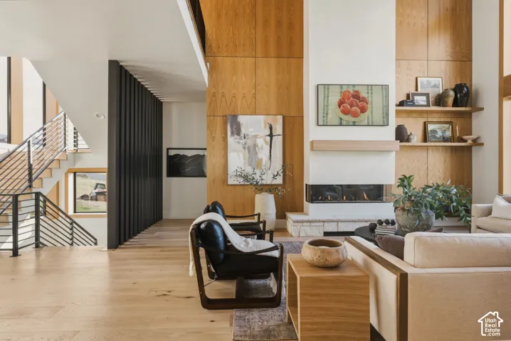 Living area featuring a floor-to-ceiling fireplace with an integrated linear gas insert and stone hearth