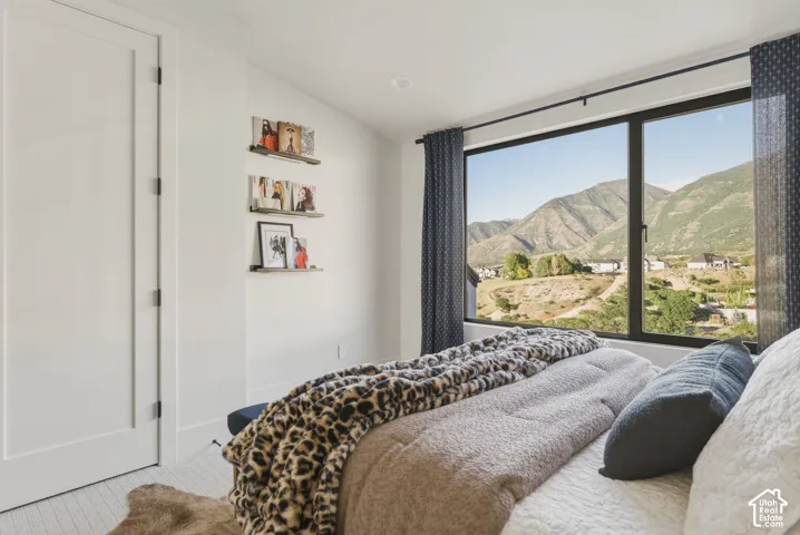 Expansive window offering a mountain landscape, complemented by a white paneled door with dark hardware