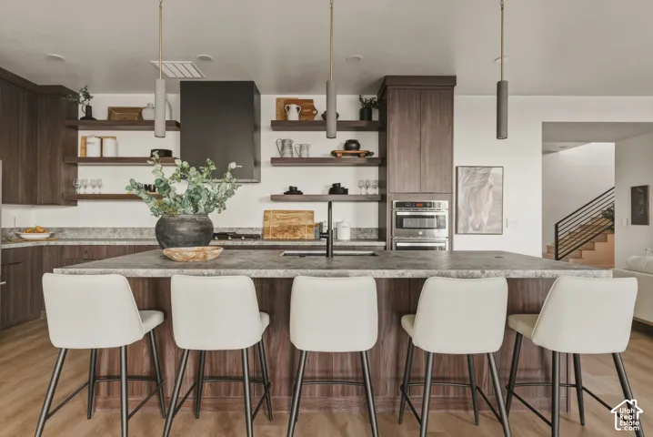 Central kitchen island featuring a substantial countertop and integrated seating