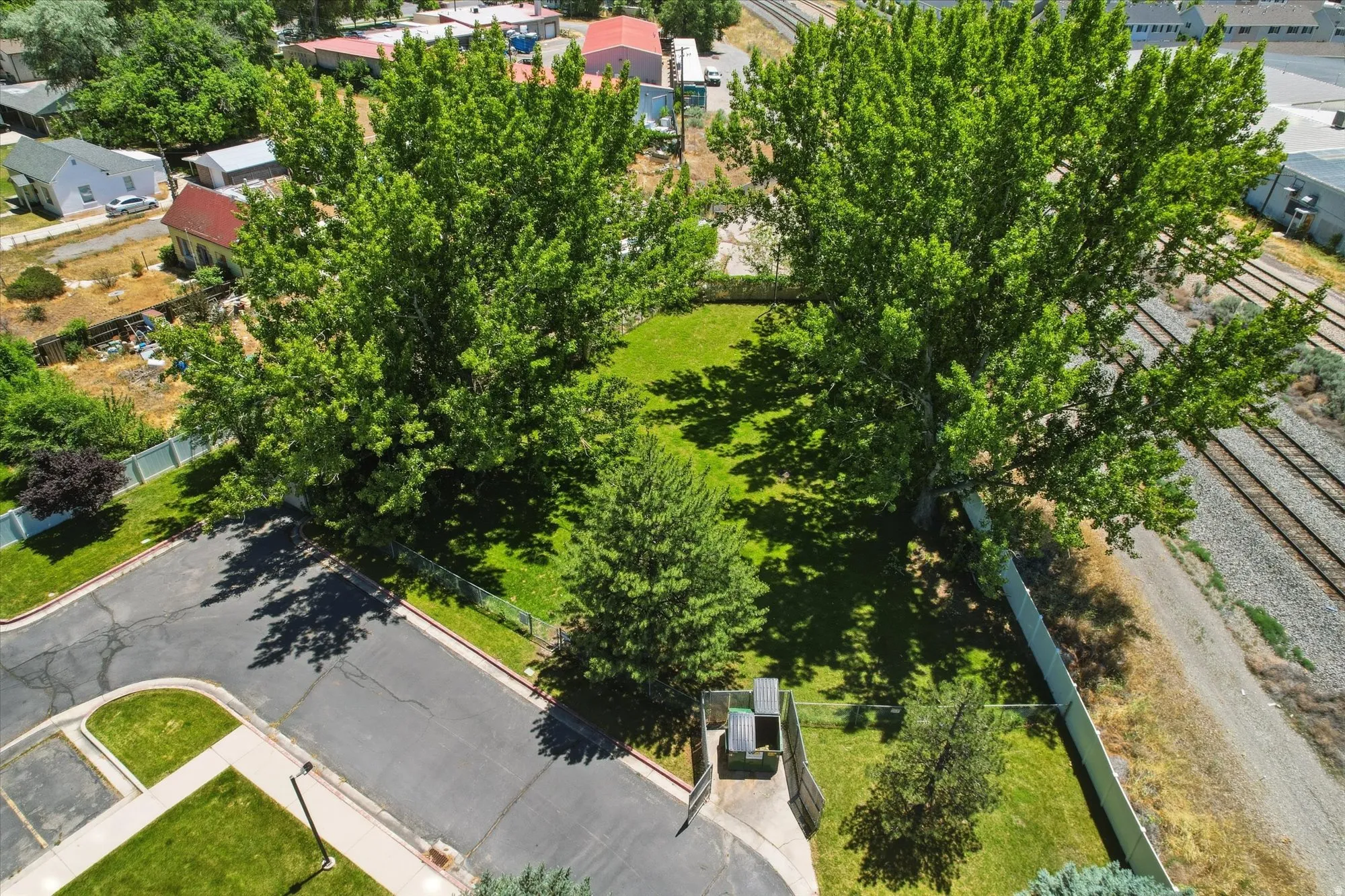 Expansive green space featuring mature trees and a manicured lawn