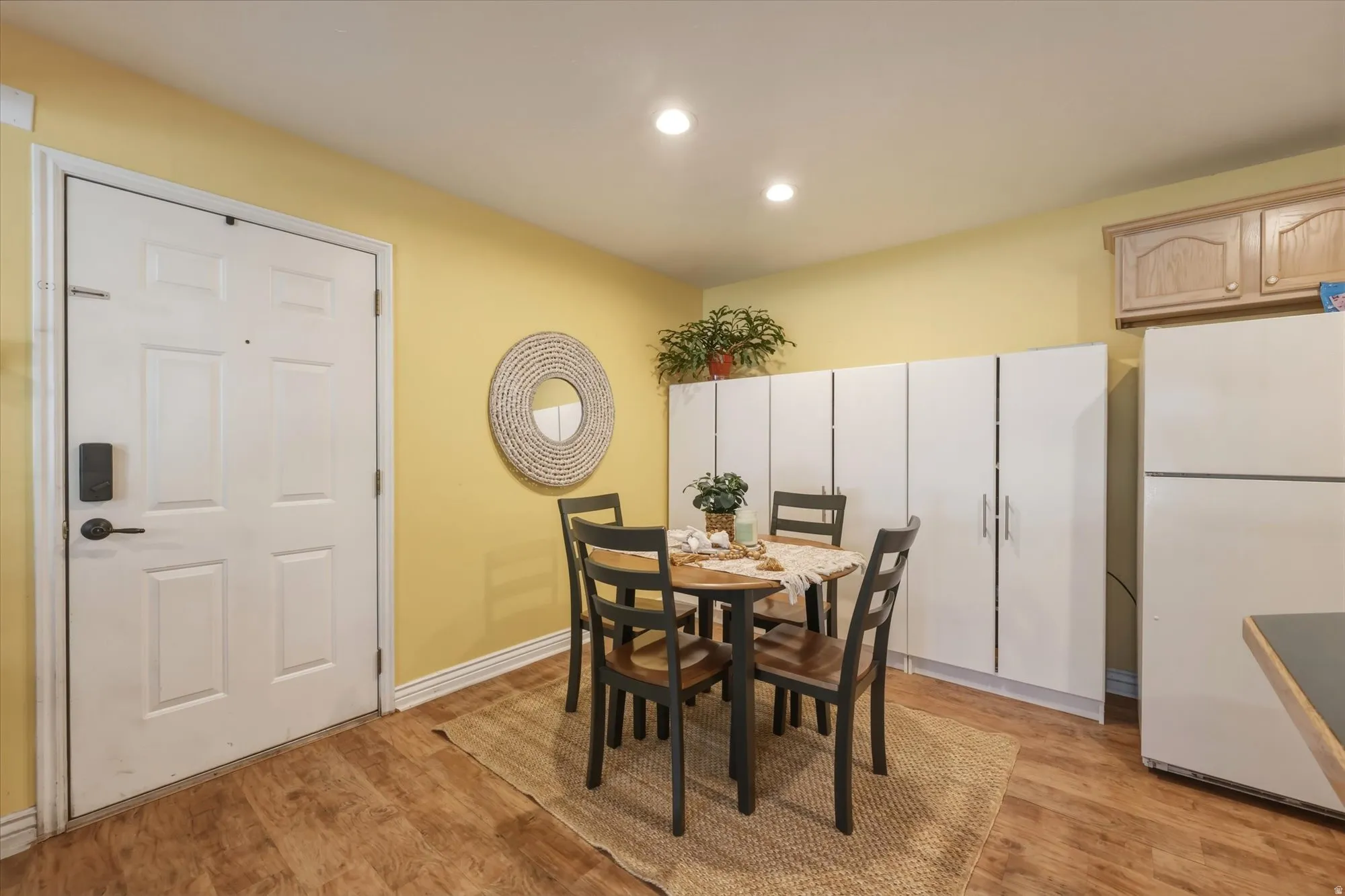 Dining area featuring wood-finish flooring and recessed lighting