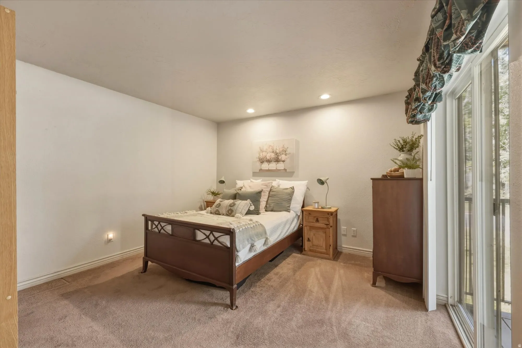 Spacious room featuring neutral wall tones, recessed lighting, and soft carpet flooring