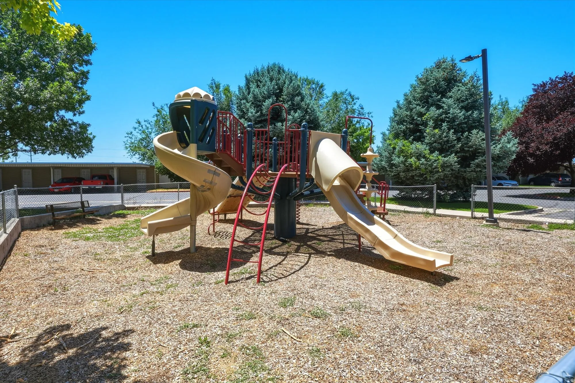 Community playground featuring a multi-level structure with slides and climbing elements