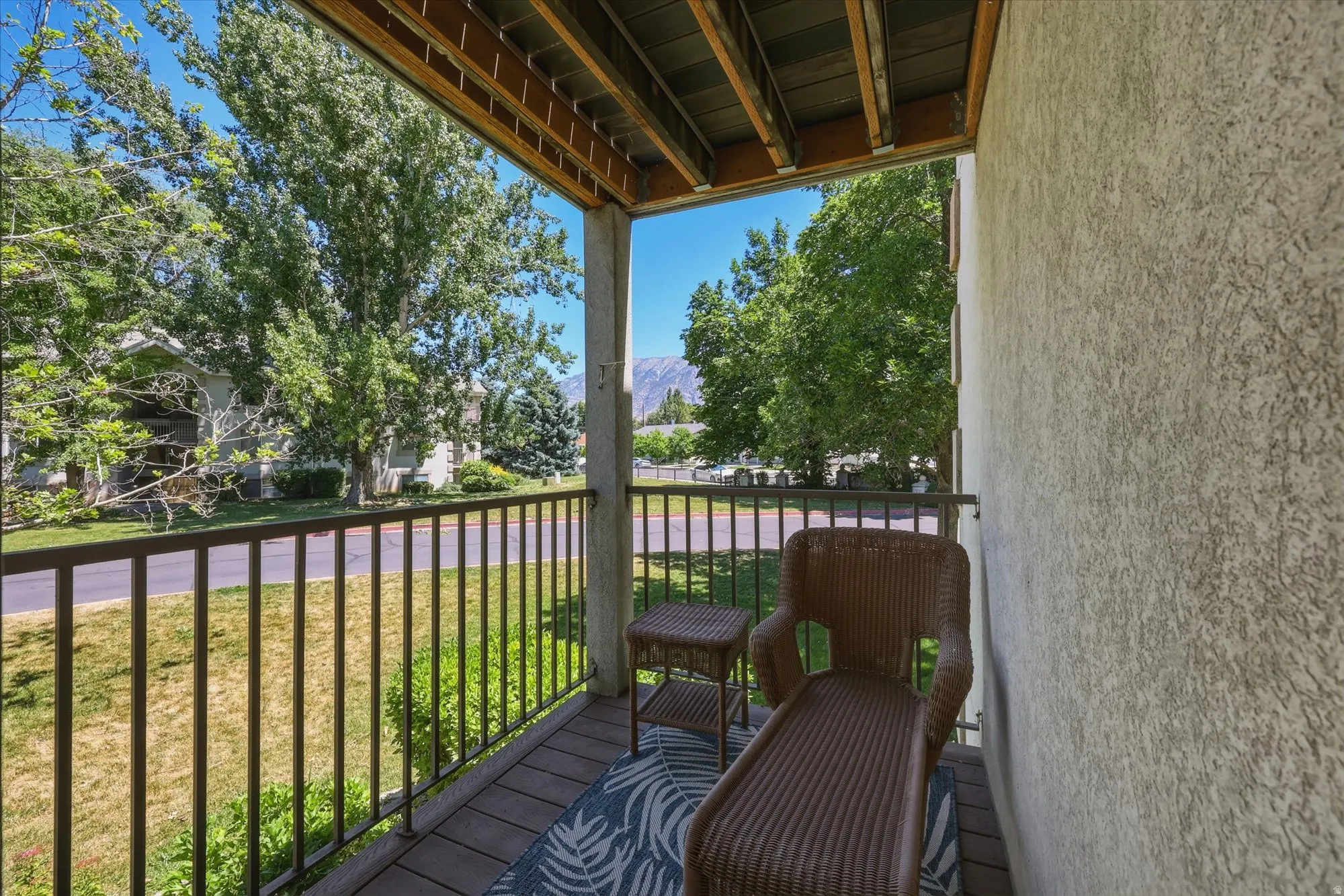 Balcony with dark metal railing and wood-finish flooring