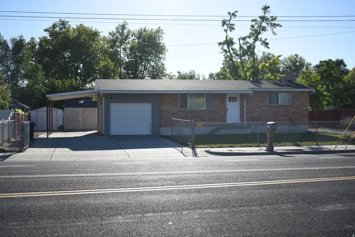 Brick and siding exterior residence with a single-car garage and attached carport