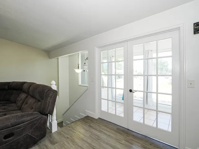 French doors with grid paneling opening to an outdoor area