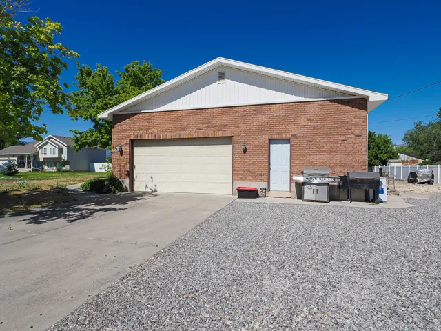 Brick exterior building with a single garage door and a side entry door