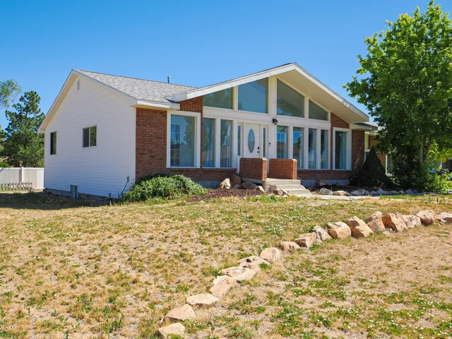 Brick and siding exterior featuring an A-frame architectural design