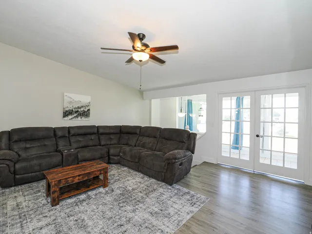 Living area featuring light wood-finish flooring and vaulted ceilings