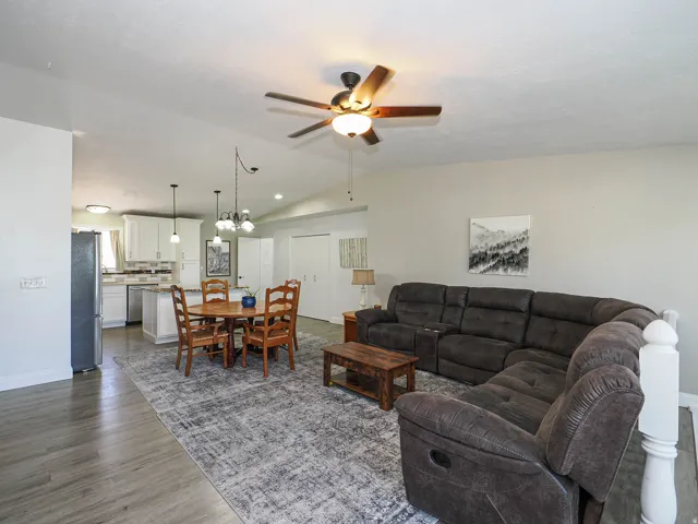Open concept living area with wood-finish flooring extending into the kitchen