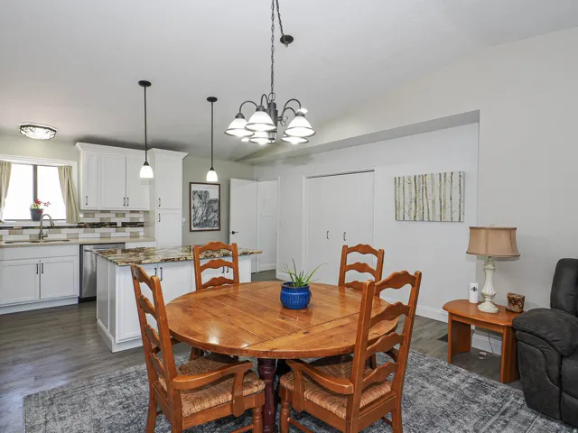 Open concept kitchen and dining area with vaulted ceiling