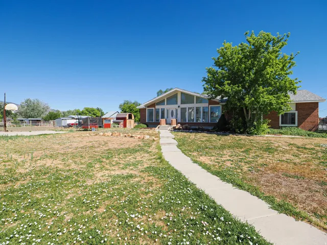 Ranch-style residence featuring a brick exterior and expansive front windows