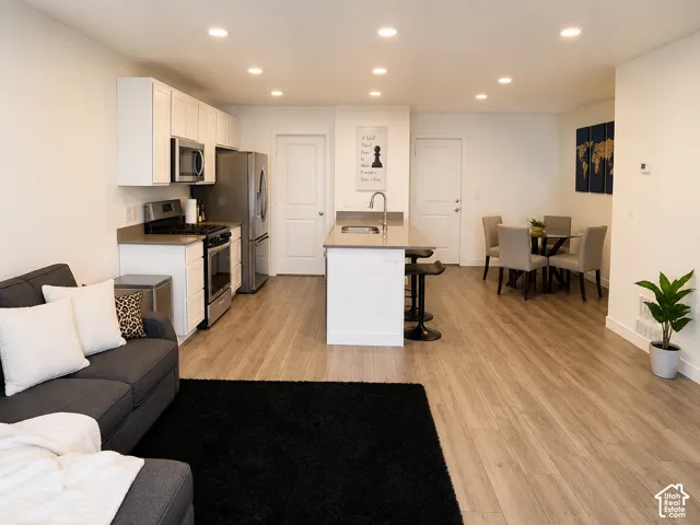 Open-concept living space featuring wood-finish flooring throughout