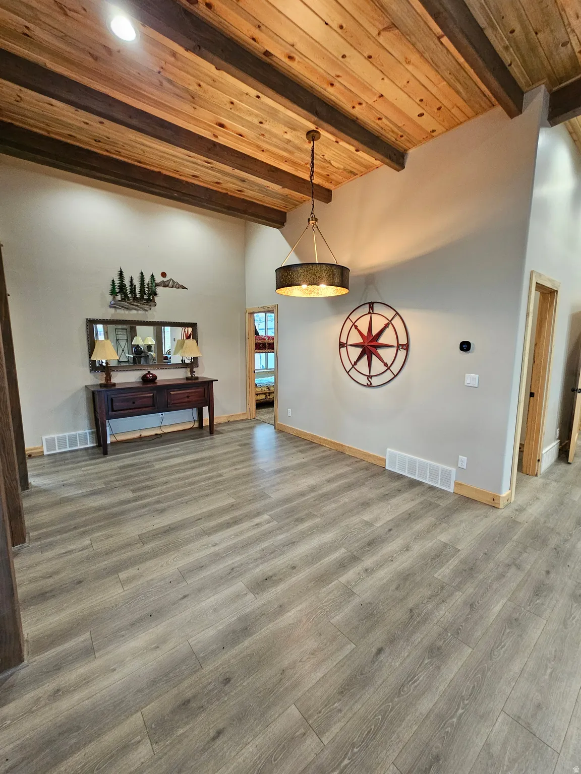 Vaulted ceiling featuring exposed wood beams and planking